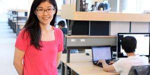 researcher with people working at laptops in the background